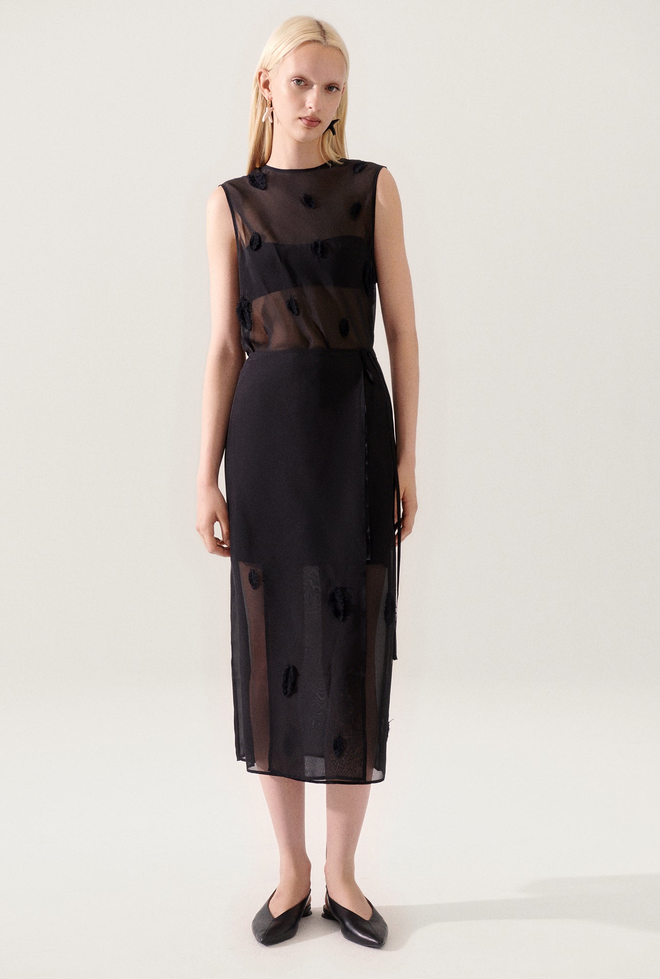 Image of a model wearing Skirts. Product name - Feather Wrap Skirt Black in Black colour by brand - Silk Laundry