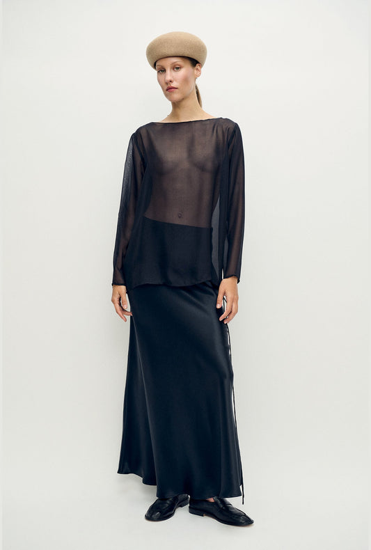 Image of a model wearing Tops. Product name - Chiffon Audrey Top Black in Black colour by brand - Silk Laundry