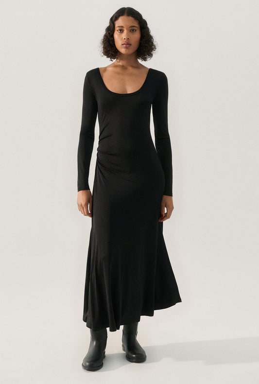 Image of a model wearing Tops. Product name - Jersey Long Sleeve Dress Black in Black colour by brand - Silk Laundry