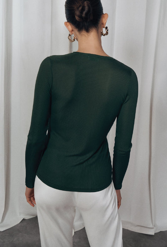 Image of a model wearing Tops. Product name - Ribbed Long Sleeve Henley Cedar in Cedar colour by brand - Silk Laundry