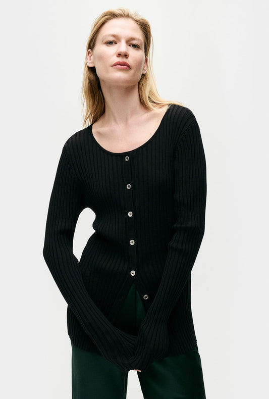 Image of a model wearing Outerwear. Productname: Silk Laundry Ribbed Kia Cardigan in Black colour by brand - Silk Laundry