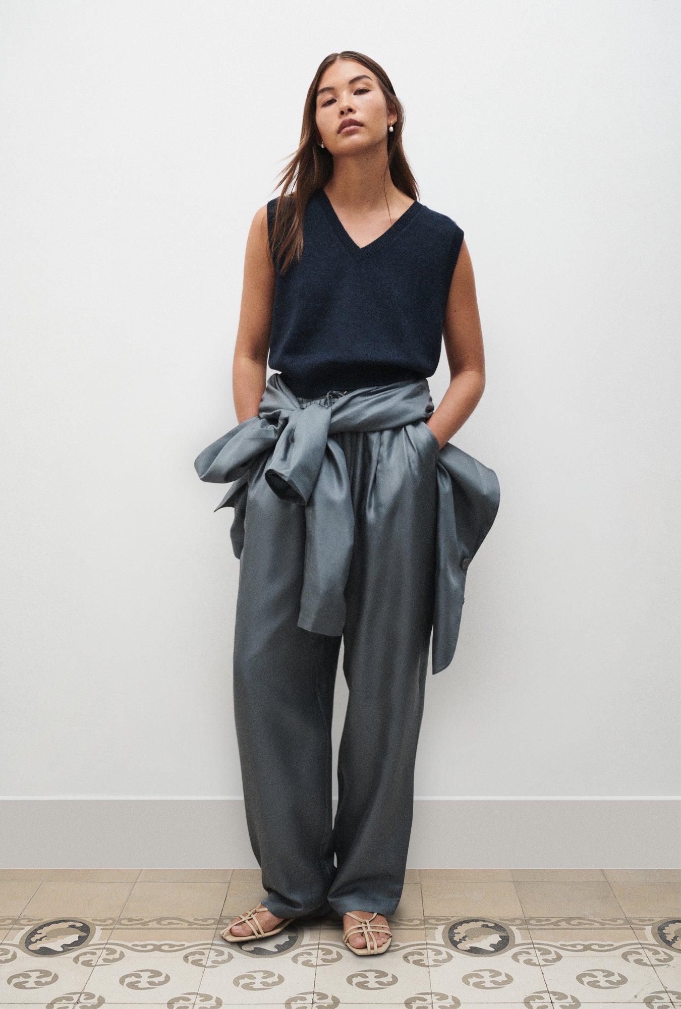 Image of a model wearing Outerwear. Product name - V-Neck Sweater Vest Azul Melange in Azul Melange colour by brand - Silk Laundry