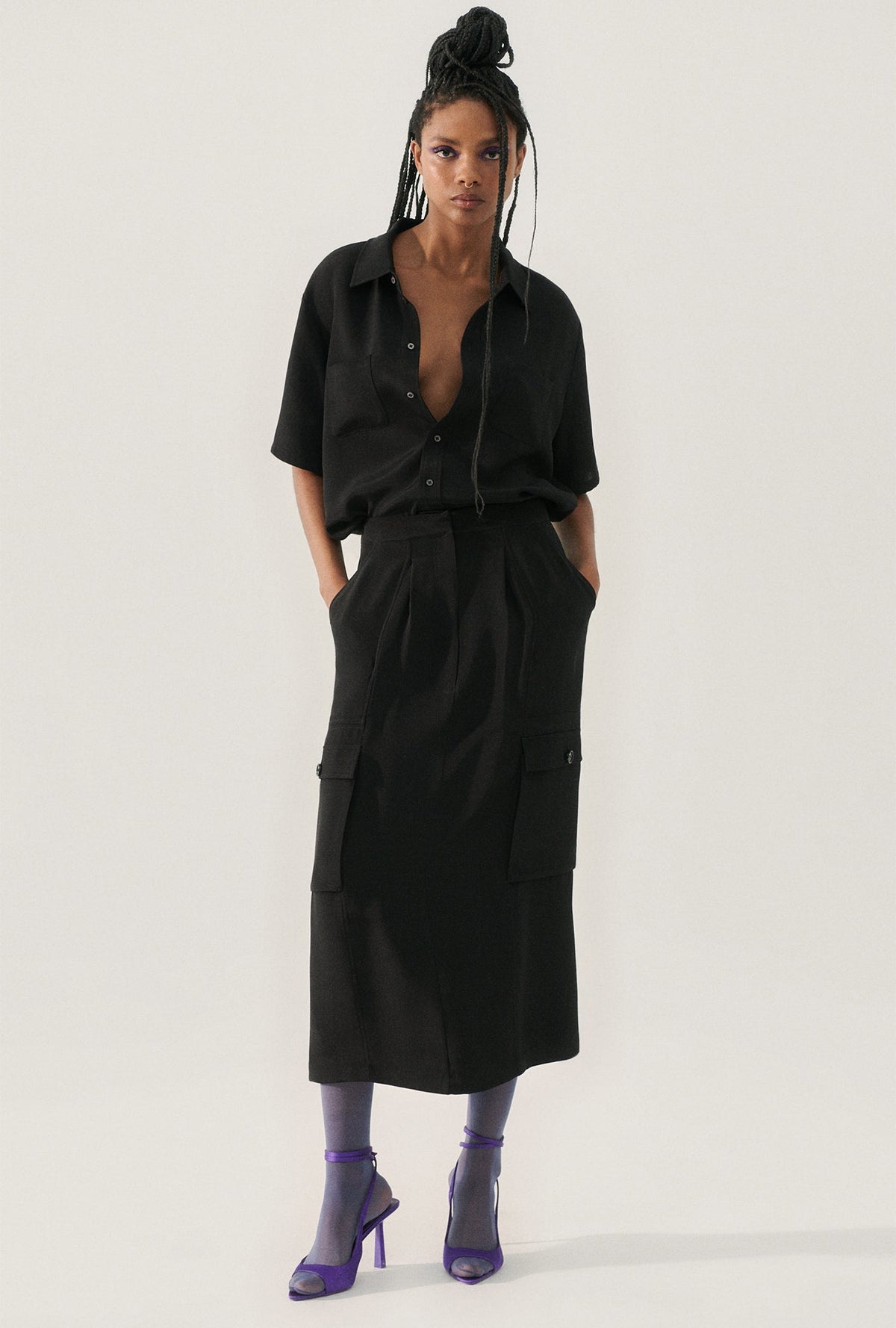 Image of a model wearing Skirts. Product name - CDC Long Suit Skirt Black in Black colour by brand - Silk Laundry