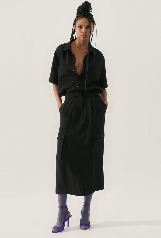 Image of a model wearing Skirts. Product name - CDC Long Suit Skirt Black in Black colour by brand - Silk Laundry