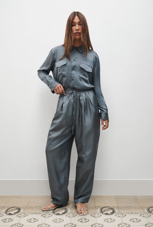 Image of a model wearing Pants. Product name - Twill Slouch Pants Slate in Slate colour by brand - Silk Laundry