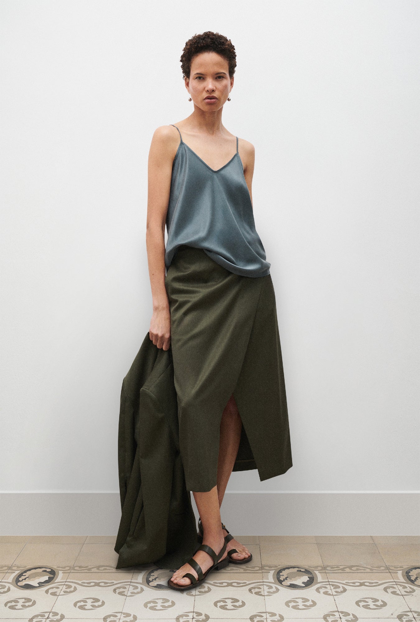 Image of a model wearing Tops. Product name - Bias Cut Cami Slate in Slate colour by brand - Silk Laundry