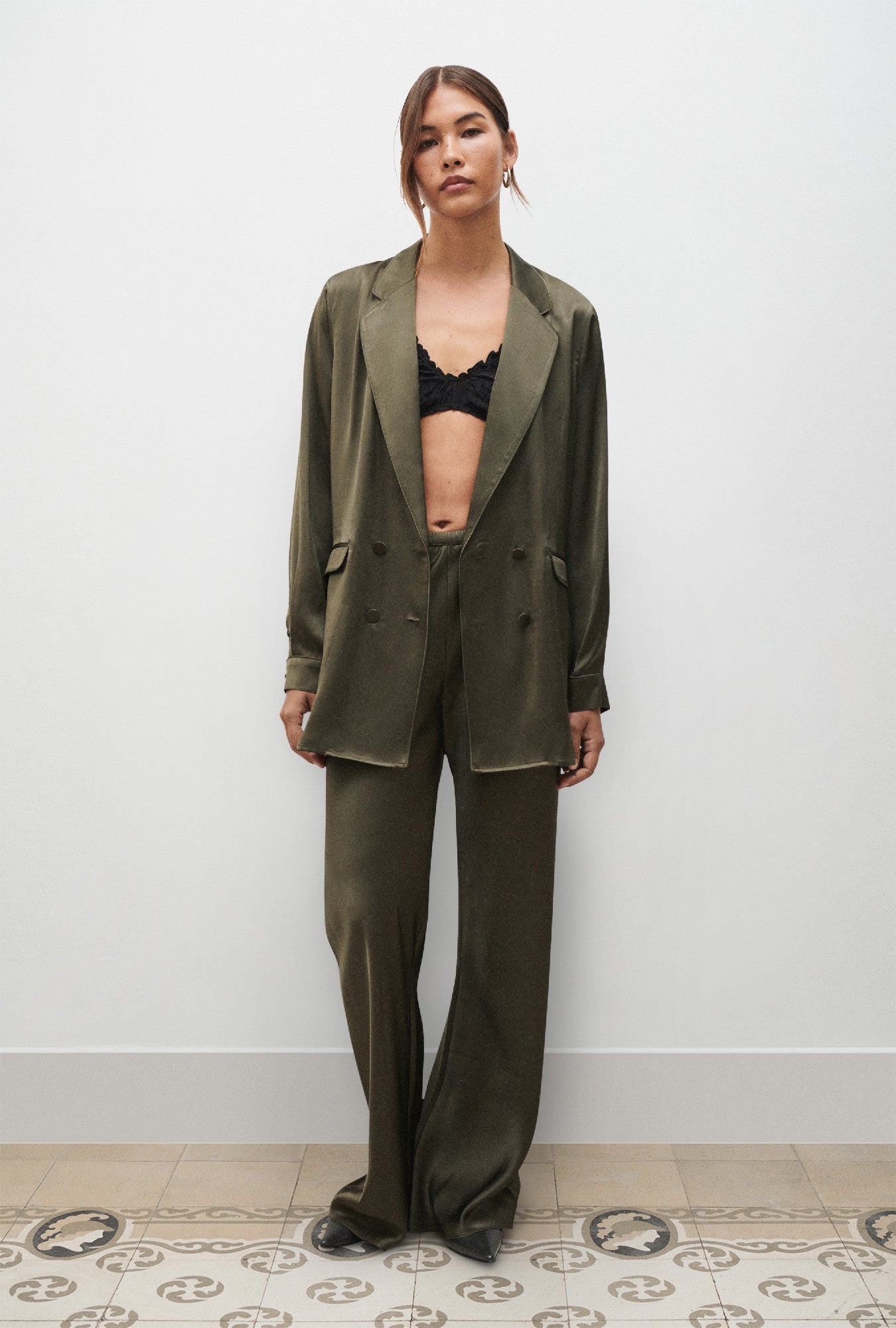 Image of a model wearing Pants. Product name - Bias Cut Pants Pine in Pine colour by brand - Silk Laundry