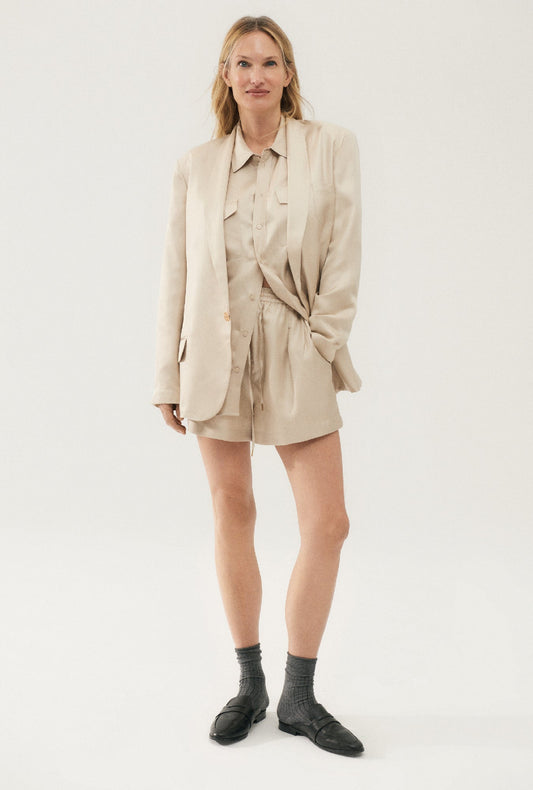 Image of a model wearing Shorts. Product name - Twill Slouch Shorts Hazelnut in Hazelnut colour by brand - Silk Laundry