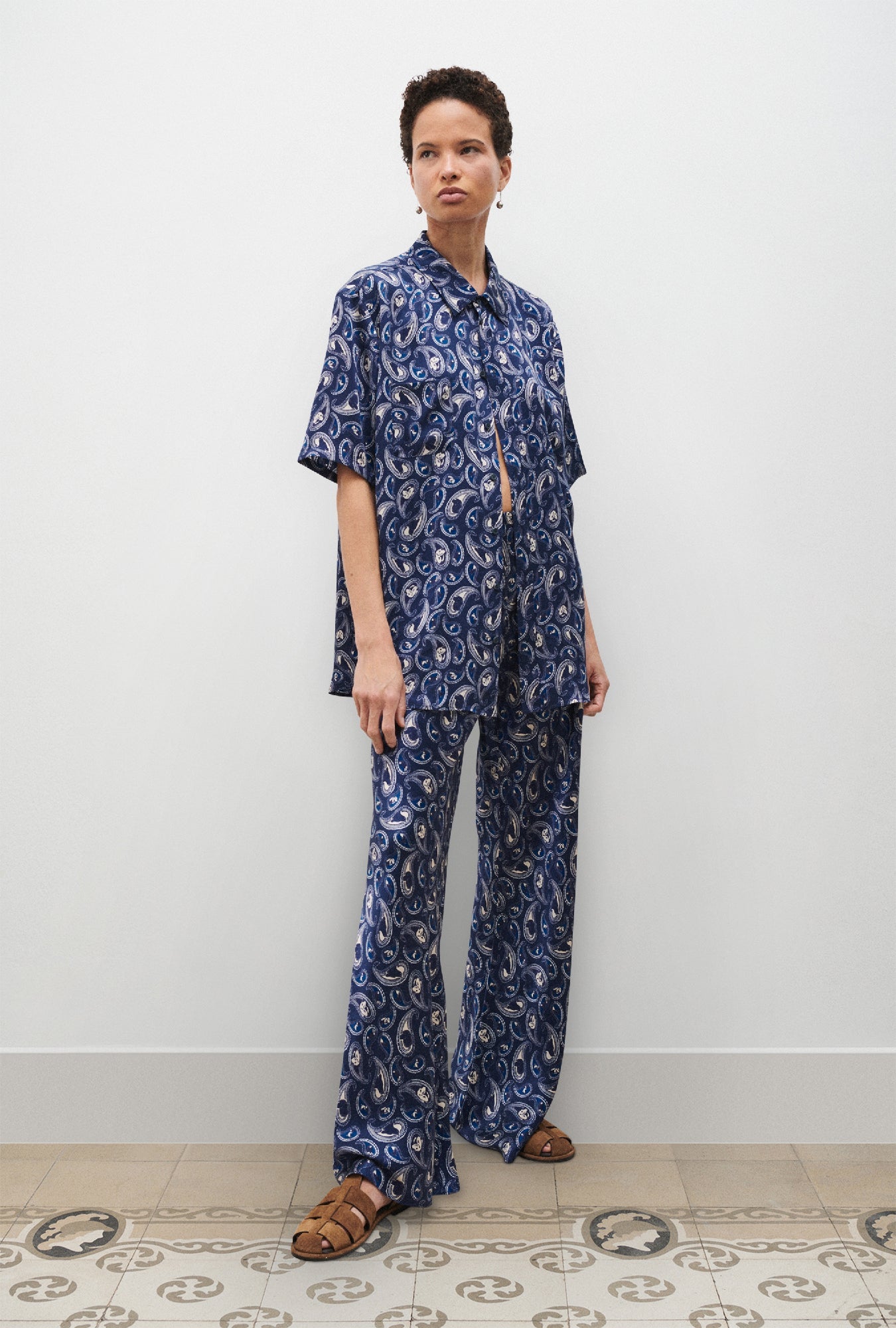 Image of a model wearing Pants. Product name - Bias Cut Pants Hounds Paisley in Hounds Paisley colour by brand - Silk Laundry