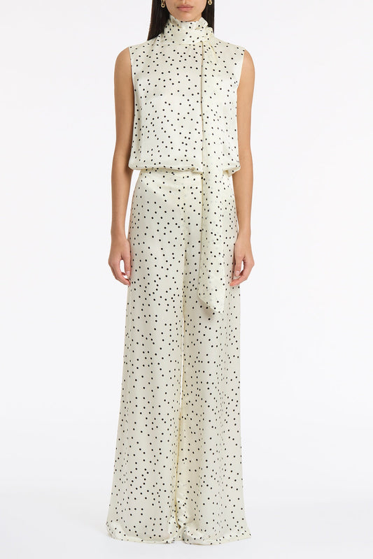 Image of a model wearing Tops. Product name - Monochrome Dot Silk Viscose Tie Neck Top in Ivory colour by brand - Carla Zampatti
