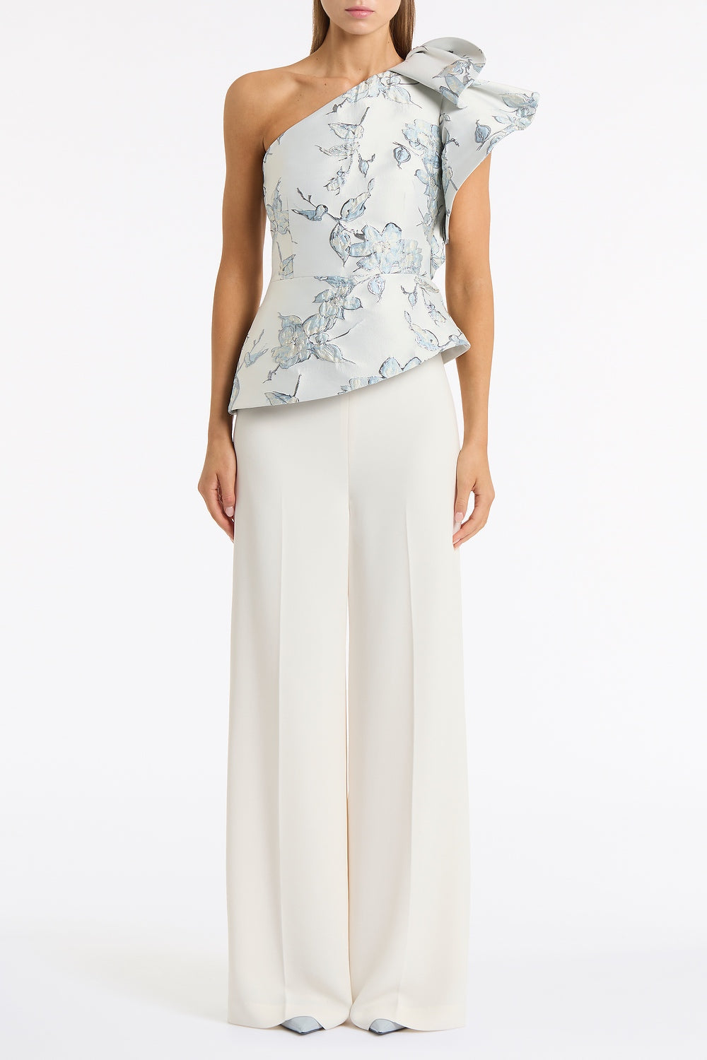 Image of a model wearing Tops. Product name - Murano Brocade Flounce Shoulder Top in White colour by brand - Carla Zampatti
