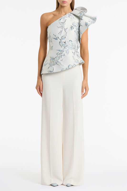 Image of a model wearing Tops. Product name - Murano Brocade Flounce Shoulder Top in White colour by brand - Carla Zampatti