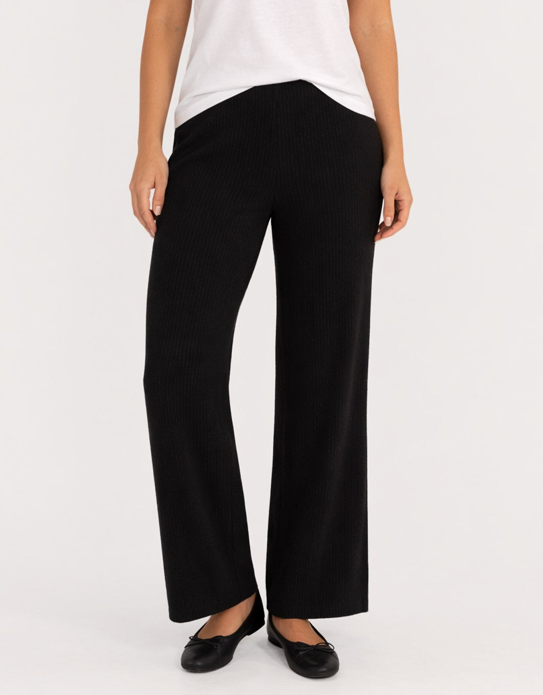 Image of a model wearing Pants. Product name - Nash Knit Pant Black in Black colour by brand - Betty Basics