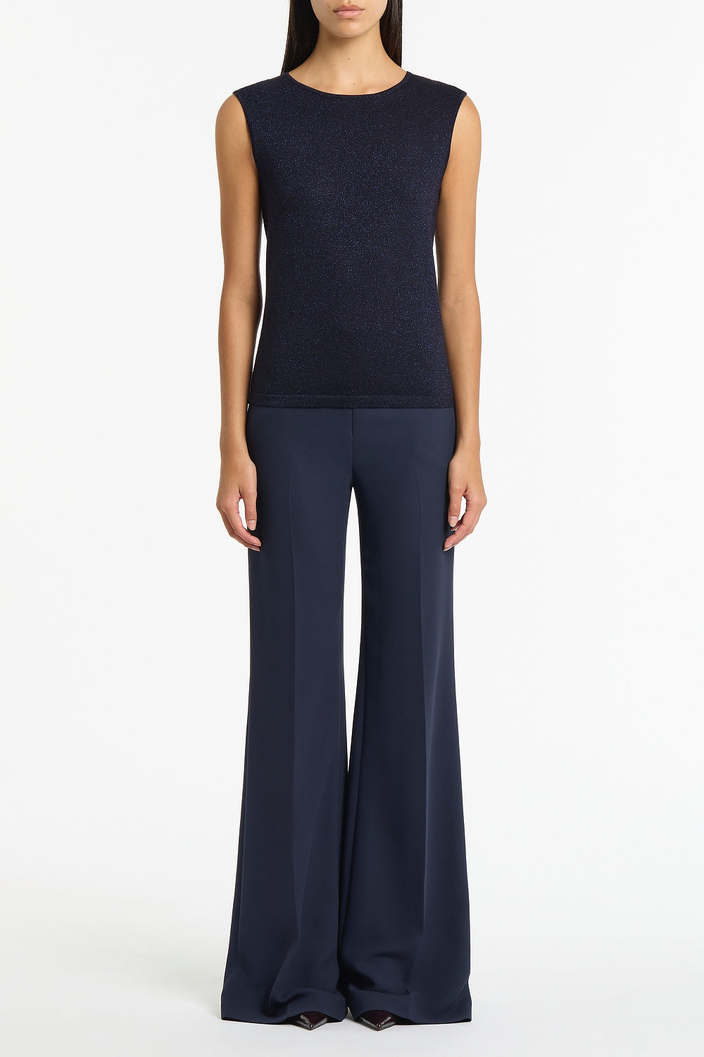 Image of a model wearing Pants. Product name - Navy Crepe Low Waist Pant in Navy colour by brand - Carla Zampatti