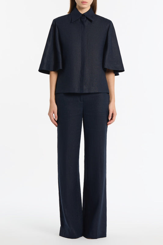 Image of a model wearing Tops. Product name - Navy Linen Short Sleeve Shirt in Navy colour by brand - Carla Zampatti