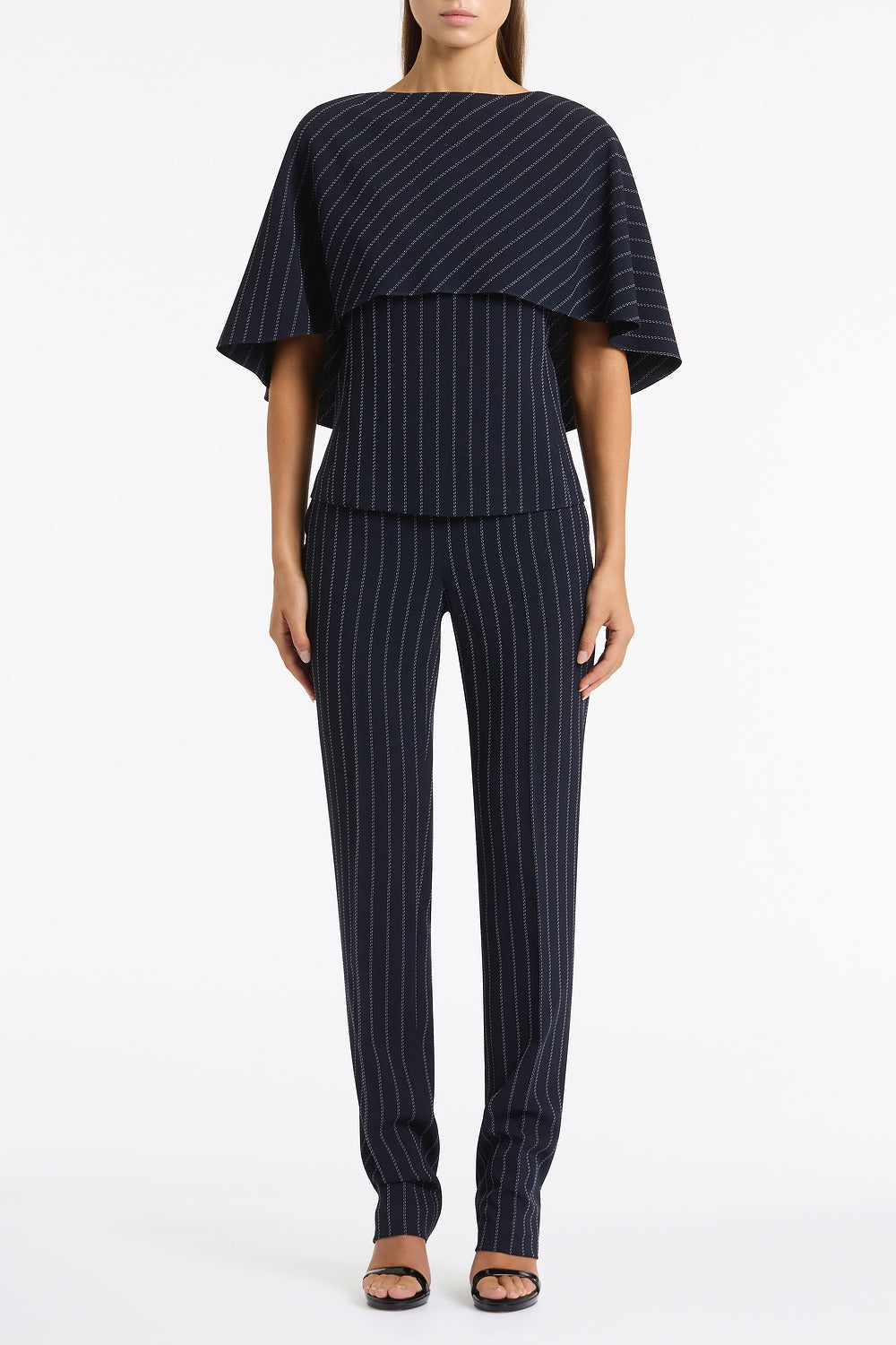 Image of a model wearing Pants. Product name - Navy Pinstripe Slim Leg Pant in Navy colour by brand - Carla Zampatti