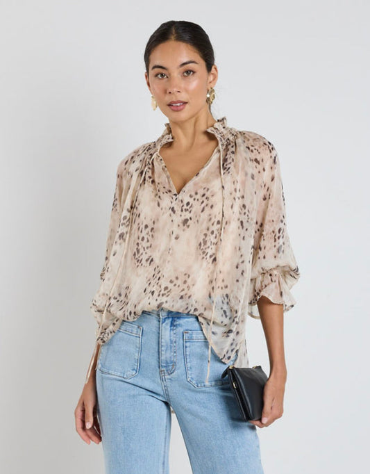 Image of a model wearing Tops. Product name - Odyssey Shirred Neck Top Beige Animal Georgette in Georgette colour by brand - Among The Brave