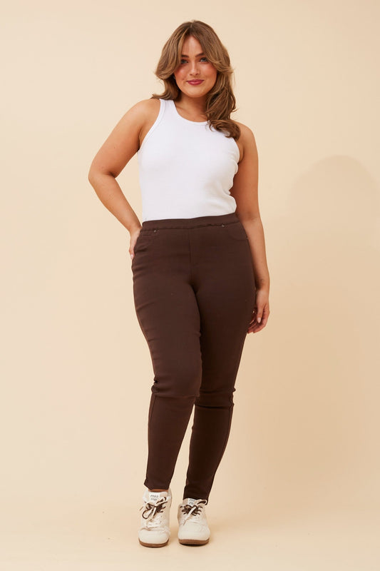 Image of a model wearing Pants. Product name - PRESLEY SKINNY PANTS in Bitter Chocolate colour by brand - Caroline Morgan Australia
