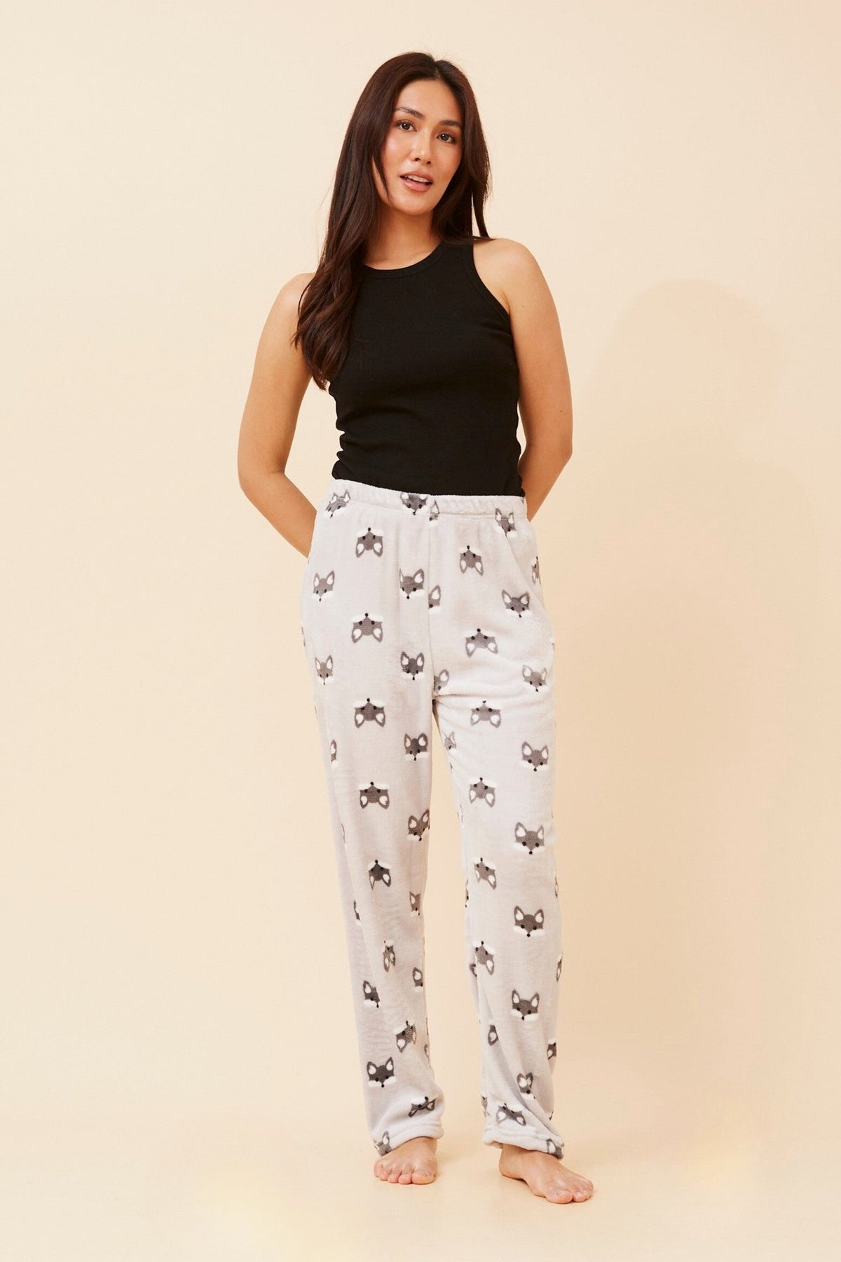 Image of a model wearing Pants. Product name - LEE FOX PRINT PLUSH PYJAMA PANTS in Pale Pink colour by brand - Caroline Morgan Australia