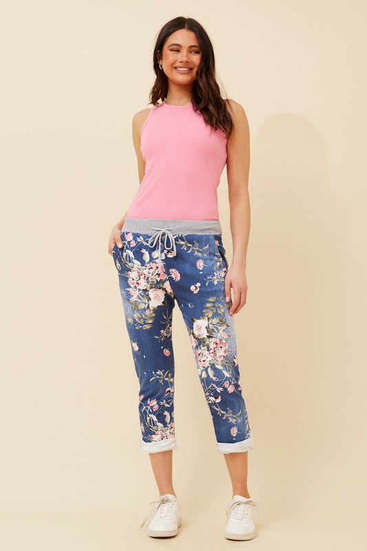 Image of a model wearing Pants. Product name - GINNA FLORAL JOGGER in Dark Denim colour by brand - BOTTEGA MODA