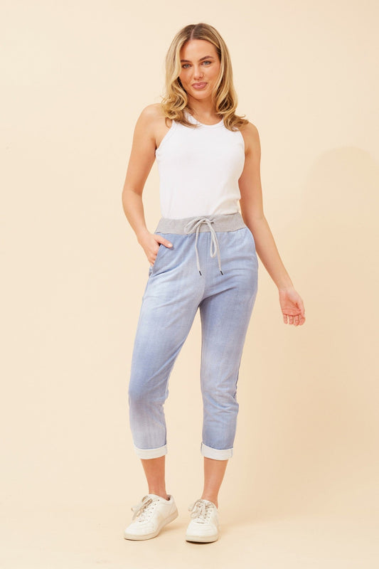 Image of a model wearing Pants. Product name - GINNA JOGGER PANTS in Denim colour by brand - BOTTEGA MODA