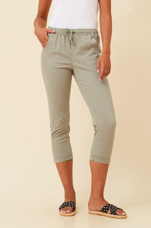 Image of a model wearing Pants. Product name - JANIA SOLID JOGGER PANTS in Sage colour by brand - Caroline Morgan Australia
