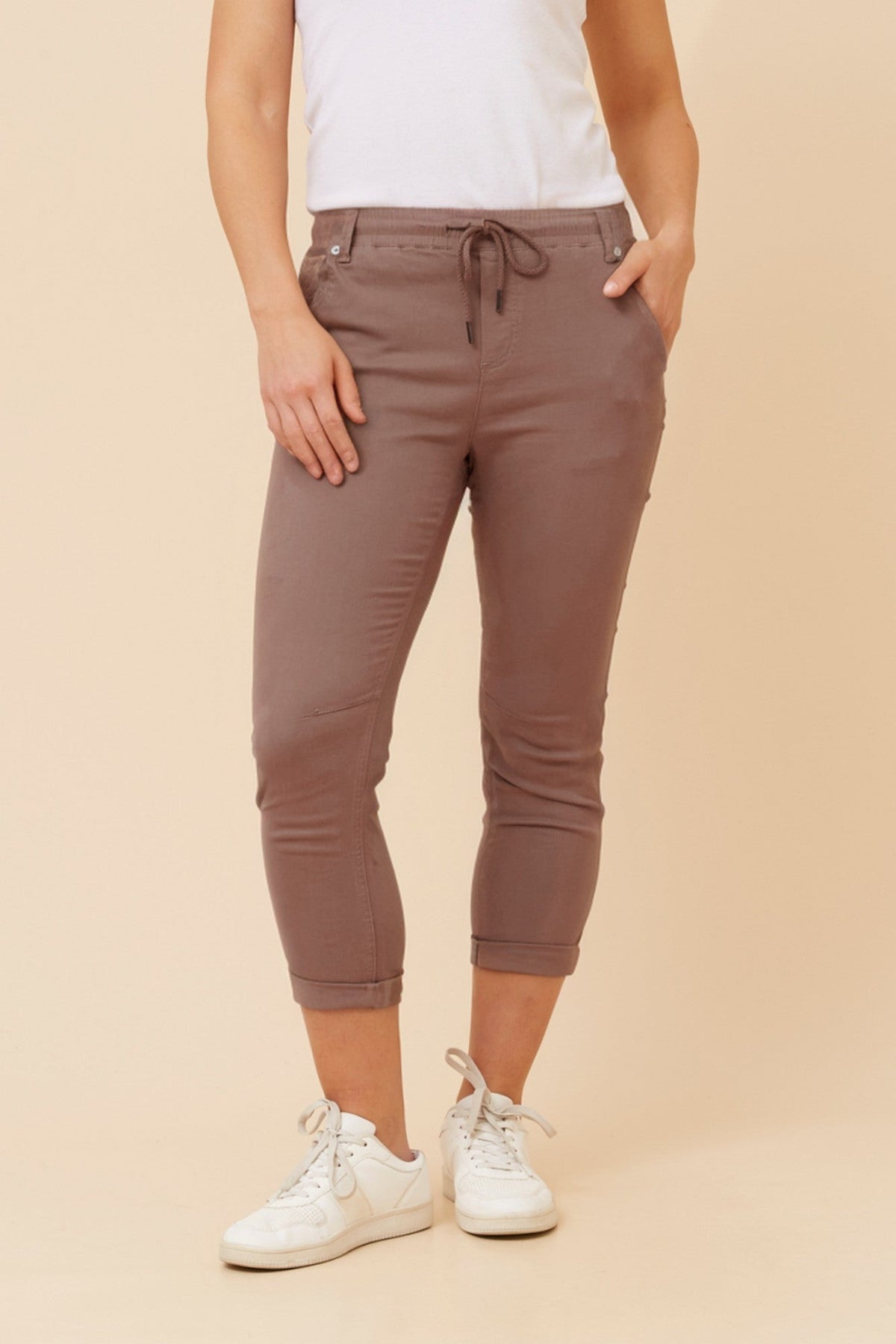 Image of a model wearing Pants. Product name - JANIA SOLID JOGGER PANTS in Walnut colour by brand - Caroline Morgan Australia