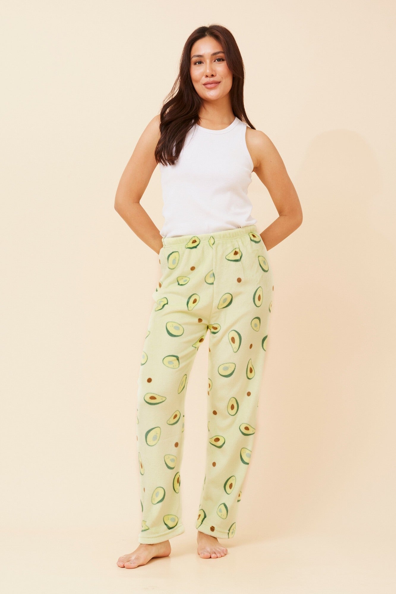 Image of a model wearing Pants. Product name - LEE AVOCADO PRINT PLUSH PYJAMA PANTS in Lime Green colour by brand - Caroline Morgan Australia