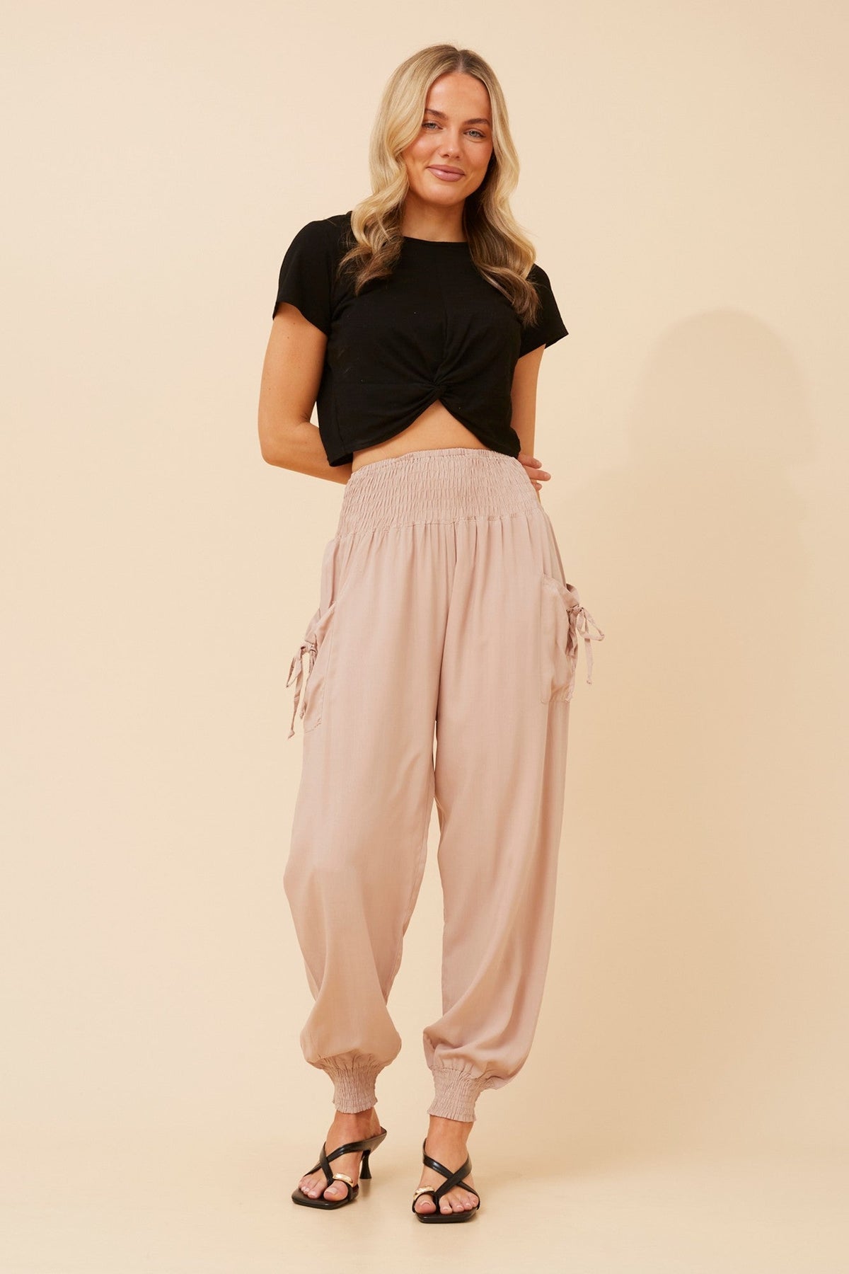Image of a model wearing Pants. Product name - SOLID HAREM PANTS in Slate colour by brand - Caroline Morgan Australia
