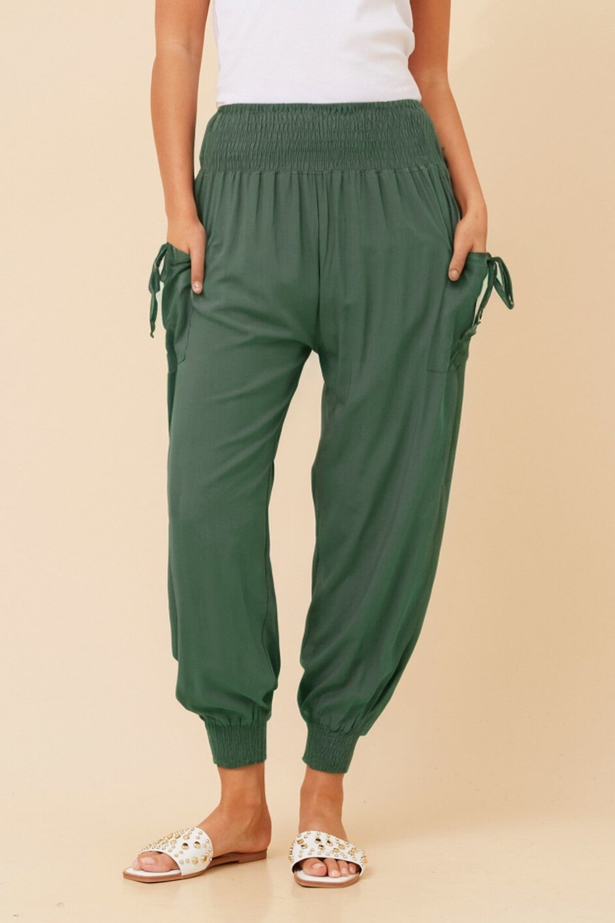 Image of a model wearing Pants. Product name - SOLID HAREM PANTS in Khaki colour by brand - Caroline Morgan Australia