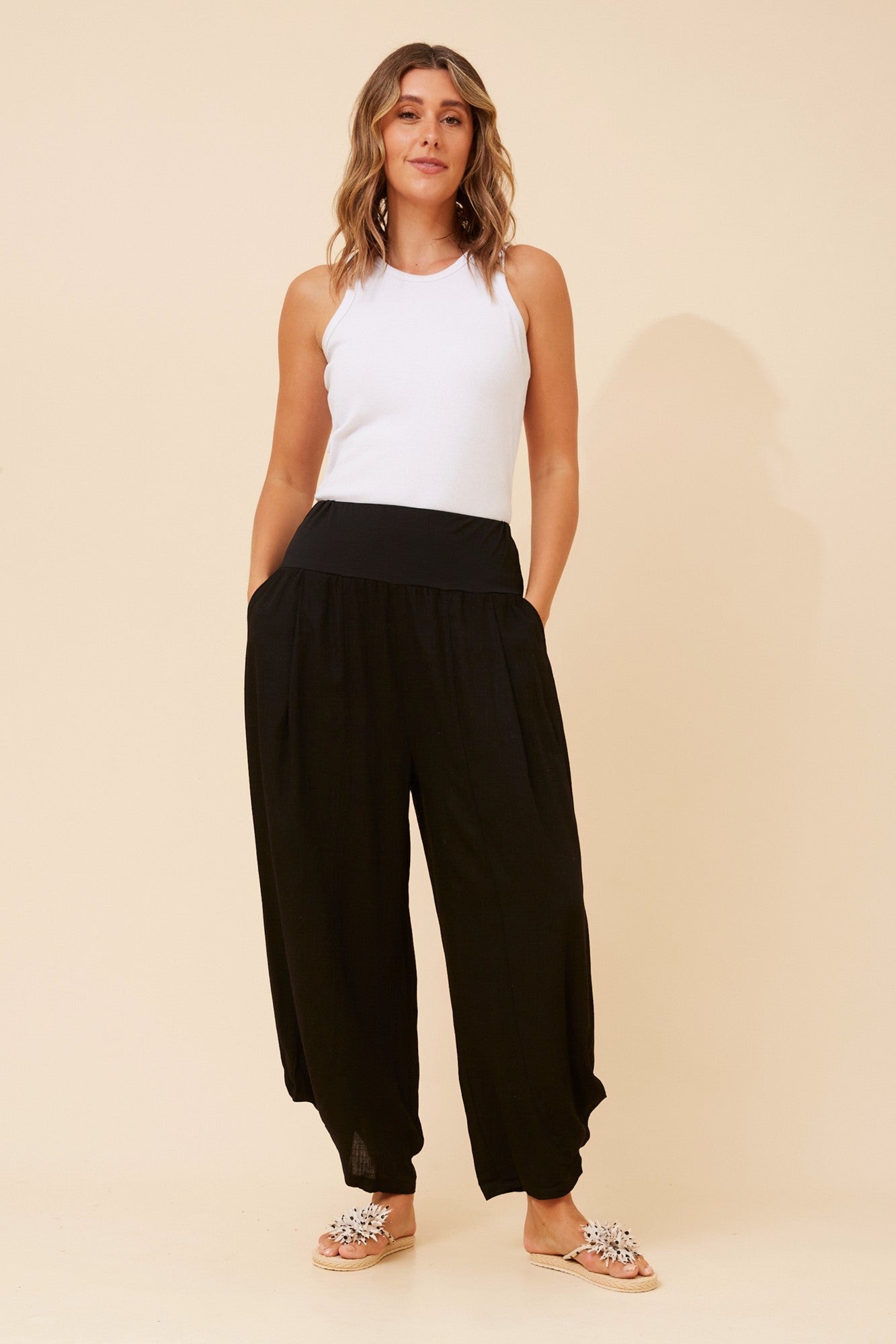 Image of a model wearing Pants. Product name - FREYA LINEN BLEND PANTS in Black colour by brand - Caroline Morgan Australia