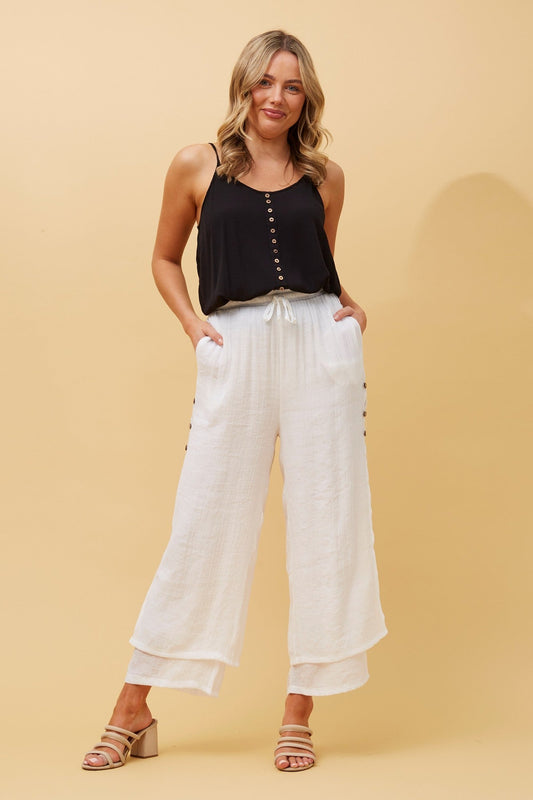 Image of a model wearing Pants. Product name - DAMIANA WIDE LEG PANTS in White colour by brand - Caroline Morgan Australia
