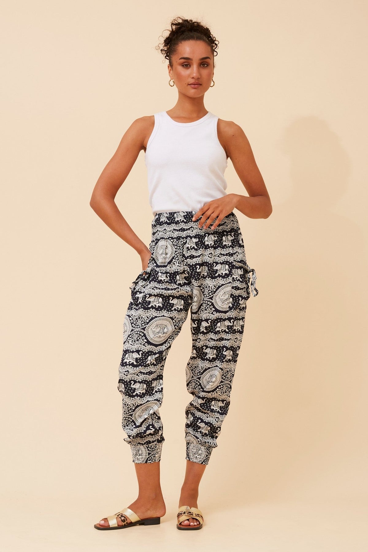 Image of a model wearing Pants. Product name - ELEPHANT PRINT HAREM PANTS in Multi Black colour by brand - Caroline Morgan Australia