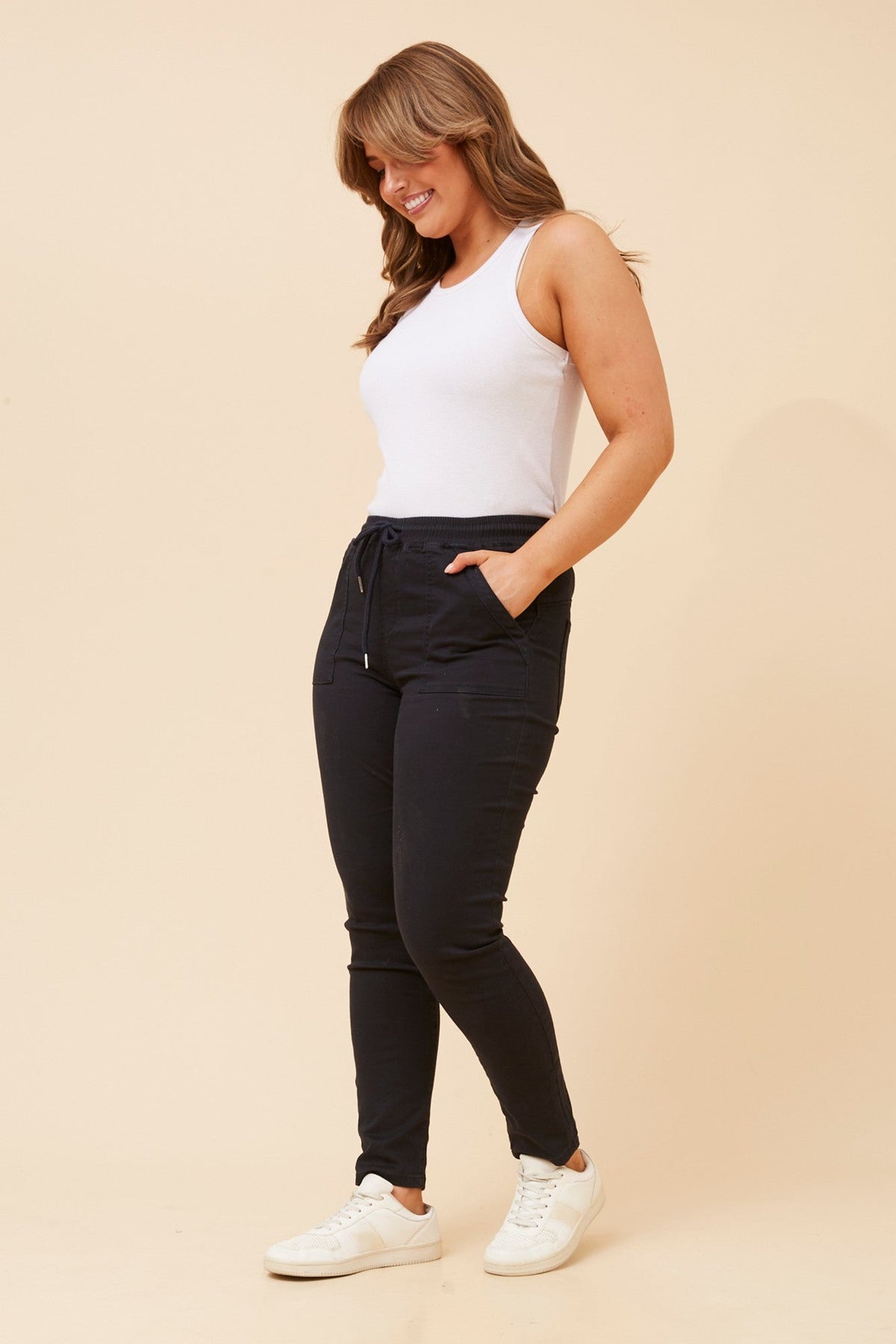 Image of a model wearing Pants. Product name - JANZA DENIM JOGGERS in Black colour by brand - INFINITY DENIM