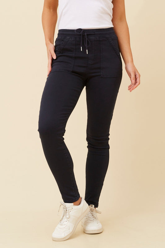 Image of a model wearing Pants. Product name - JANZA DENIM JOGGERS in Navy colour by brand - INFINITY DENIM