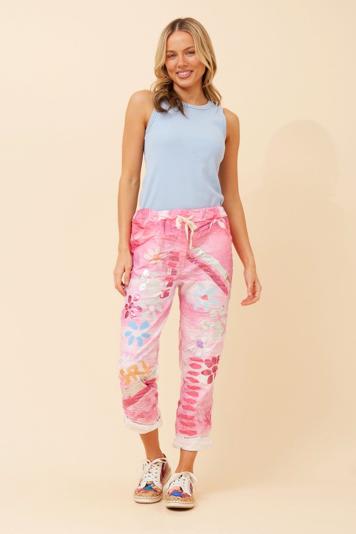 Image of a model wearing Pants. Product name - JANJA FLORAL JOGGER PANTS in Navy colour by brand - BOTTEGA MODA