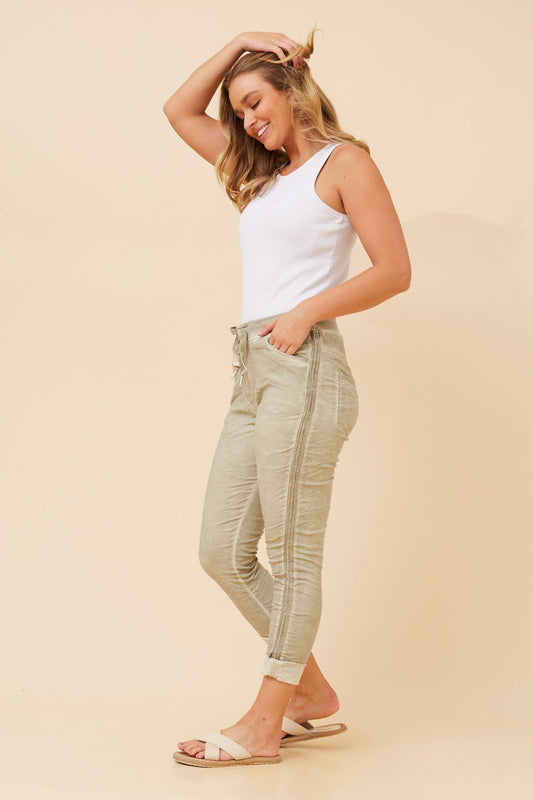 Image of a model wearing Pants. Product name - ZANJA DIAMANTE DETAIL JOGGER PANTS in Light Khaki colour by brand - BOTTEGA MODA