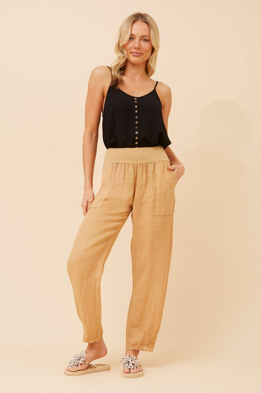 Image of a model wearing Pants. Product name - FINN SOLID LINEN PANTS in Cipolla colour by brand - BOTTEGA MODA