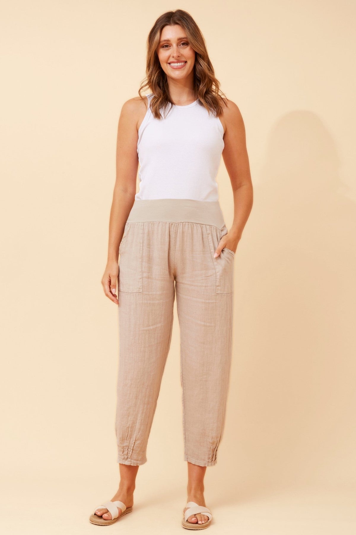 Image of a model wearing Pants. Product name - FINN SOLID LINEN PANTS in Linen colour by brand - BOTTEGA MODA