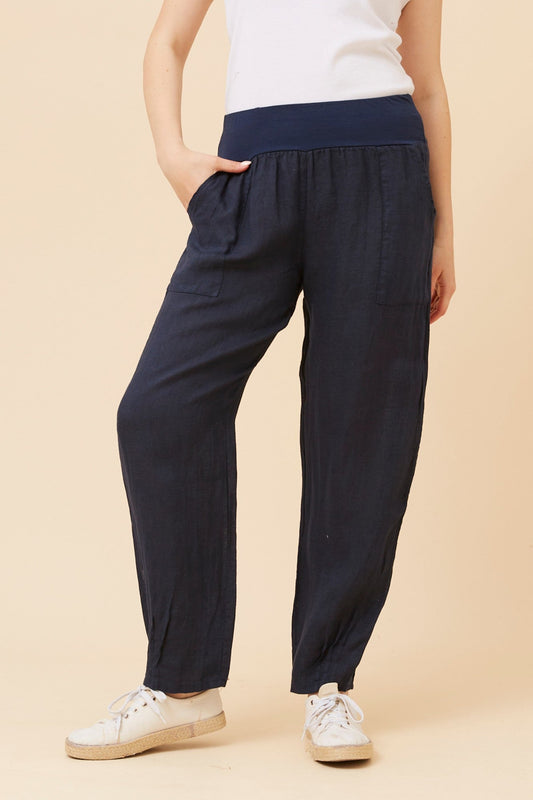 Image of a model wearing Pants. Product name - FINN SOLID LINEN PANTS in Navy colour by brand - BOTTEGA MODA