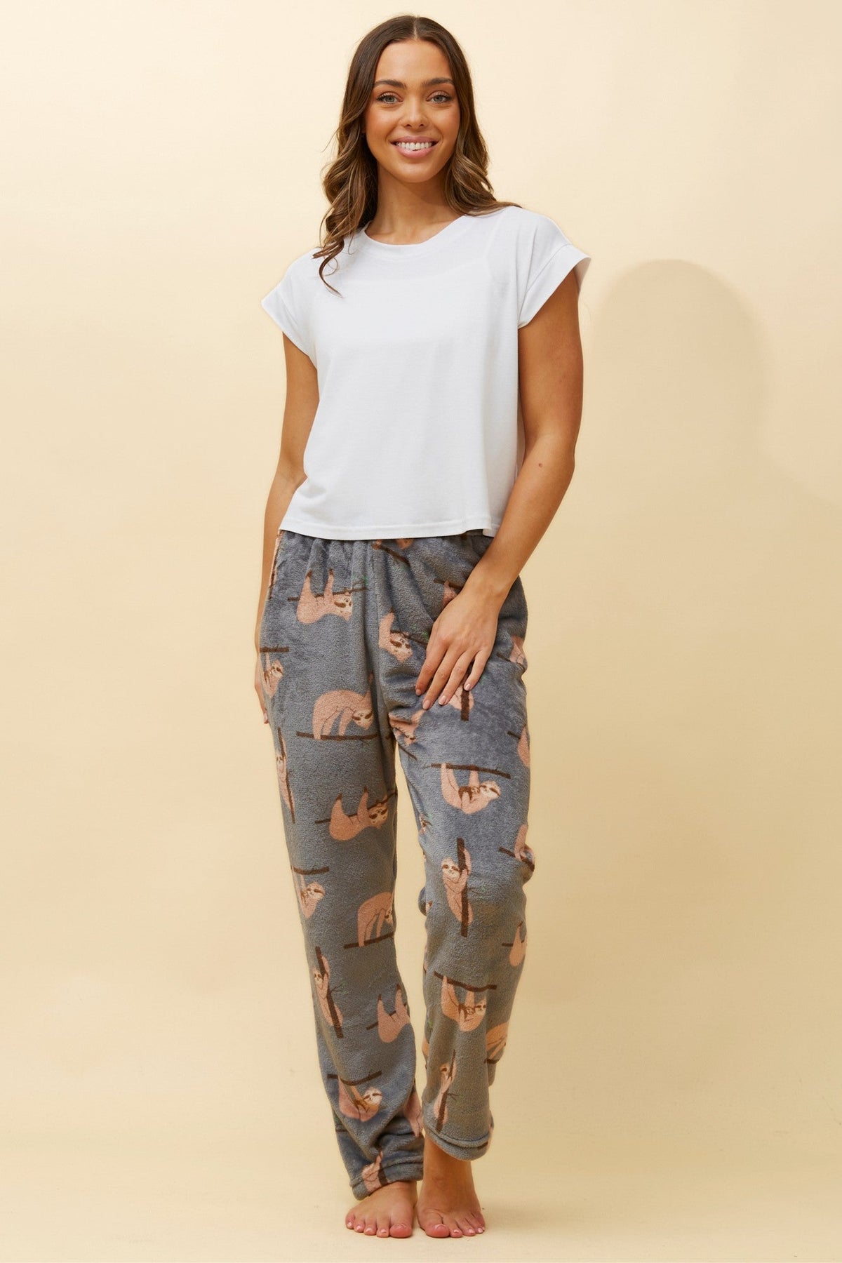 Image of a model wearing Pants. Product name - LEE SLOTH PRINT PYJAMA PANTS in Black colour by brand - Caroline Morgan Australia
