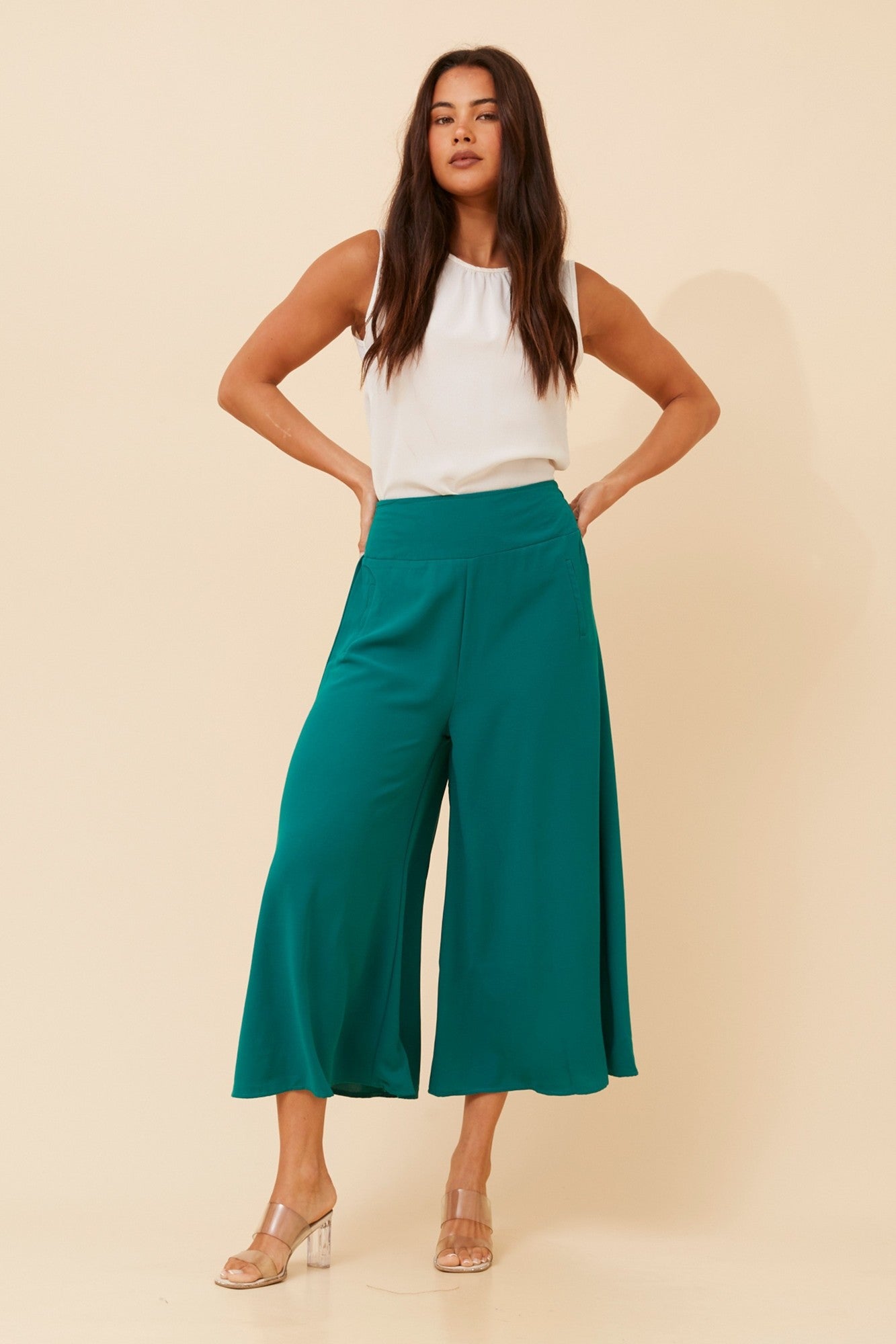 Image of a model wearing Pants. Product name - AVARA WIDE LEG PANTS in Black colour by brand - Caroline Morgan Australia