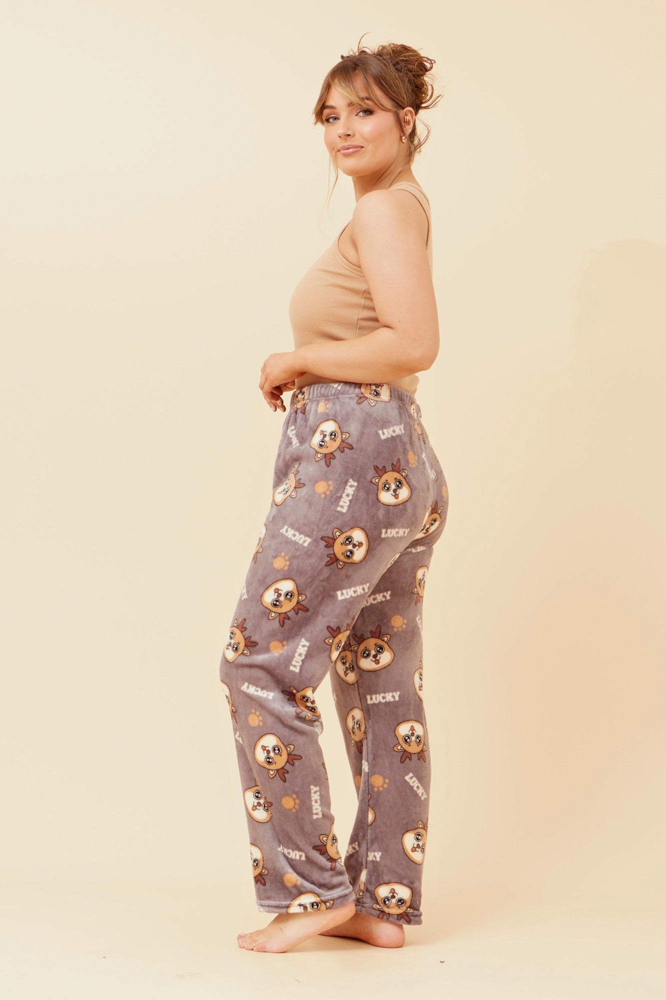 Image of a model wearing Pants. Product name - LEE REINDEER PRINT PLUSH PYJAMA PANTS in Grey colour by brand - Caroline Morgan Australia