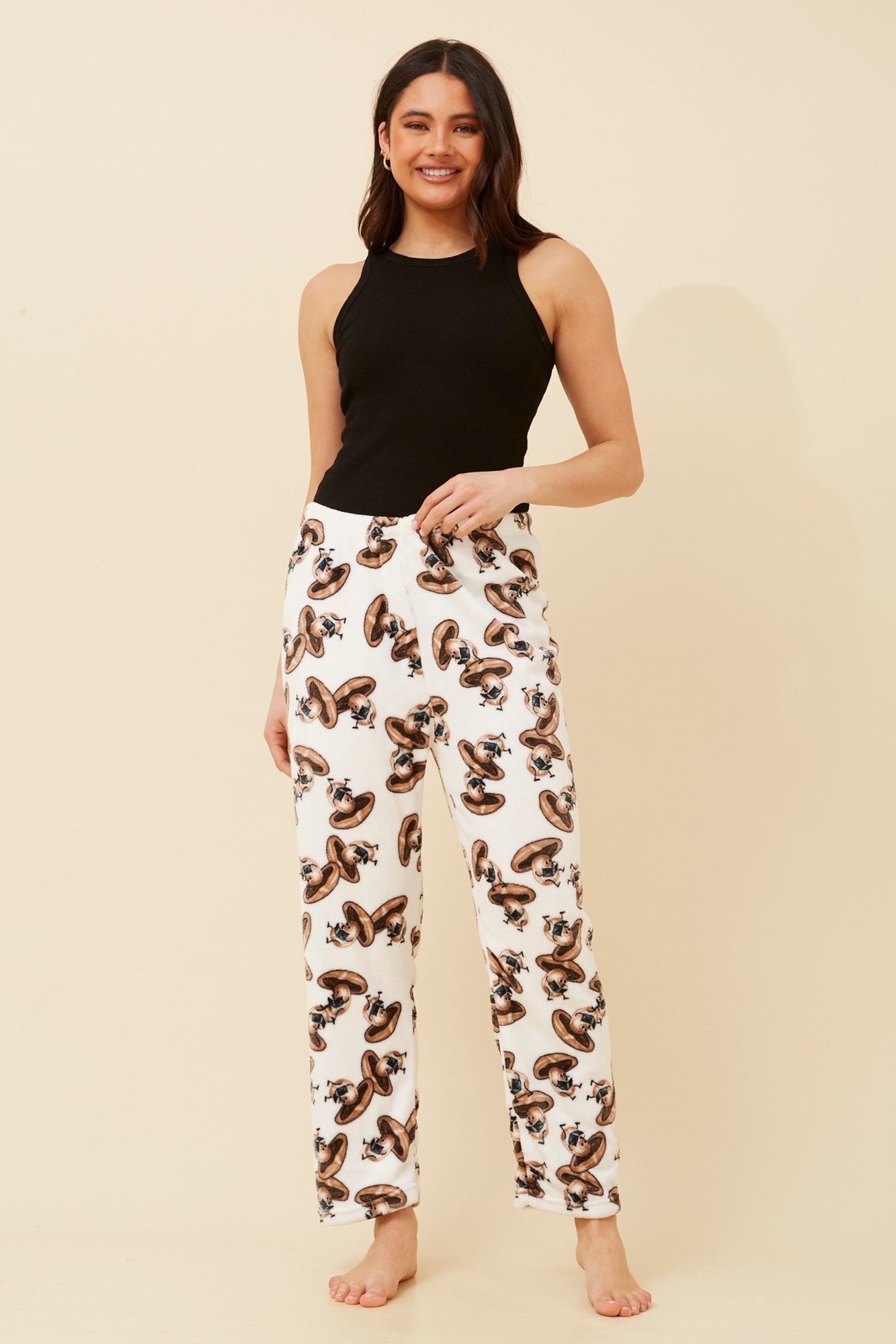 Image of a model wearing Pants. Product name - LEE MUSHROOM PRINT PLUSH PYJAMA PANTS in Multi White colour by brand - Caroline Morgan Australia