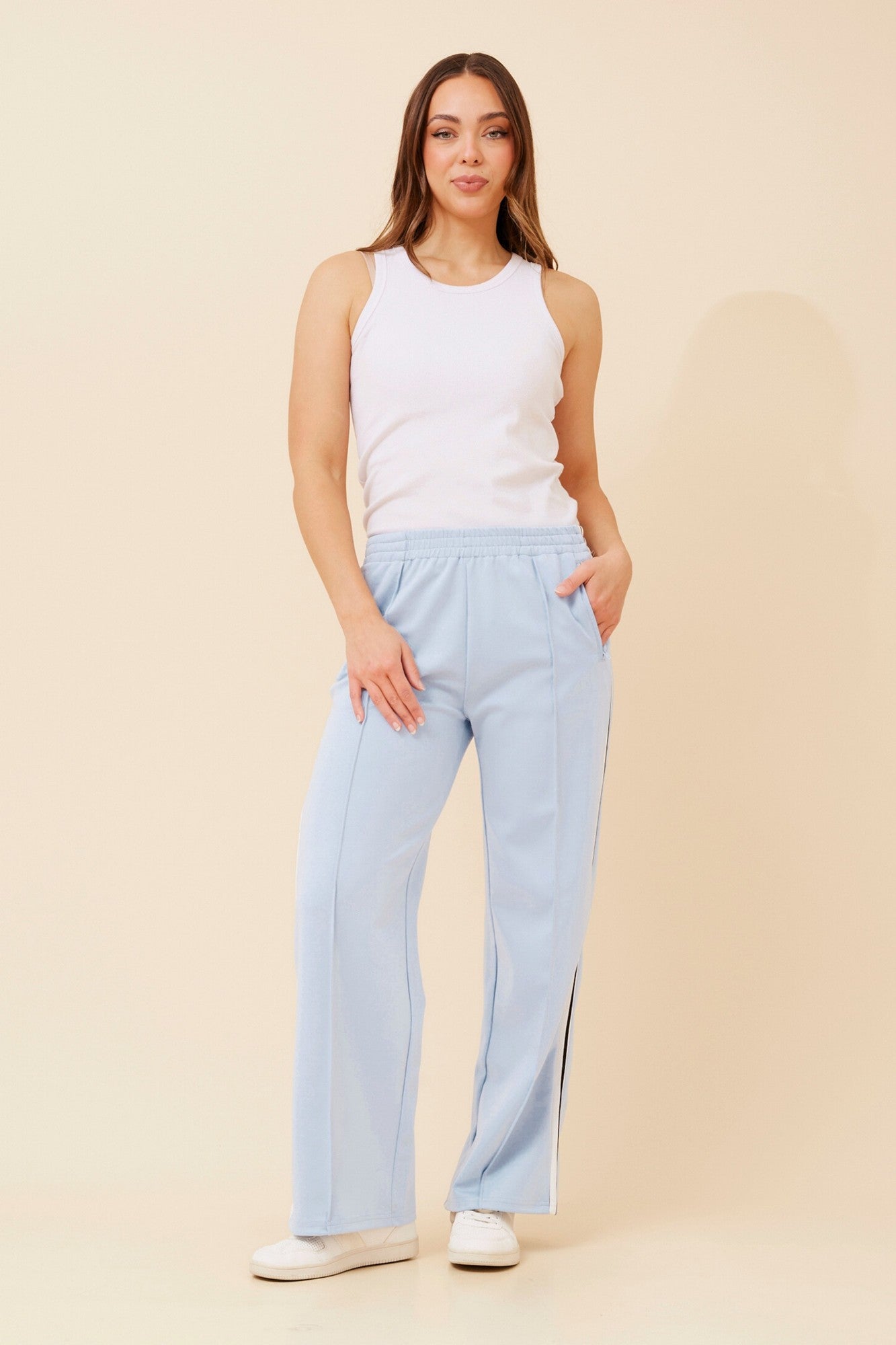 Image of a model wearing Pants. Product name - ORTENSA SIDE STRIPE PANTS in Bitter Chocolate colour by brand - Caroline Morgan Australia
