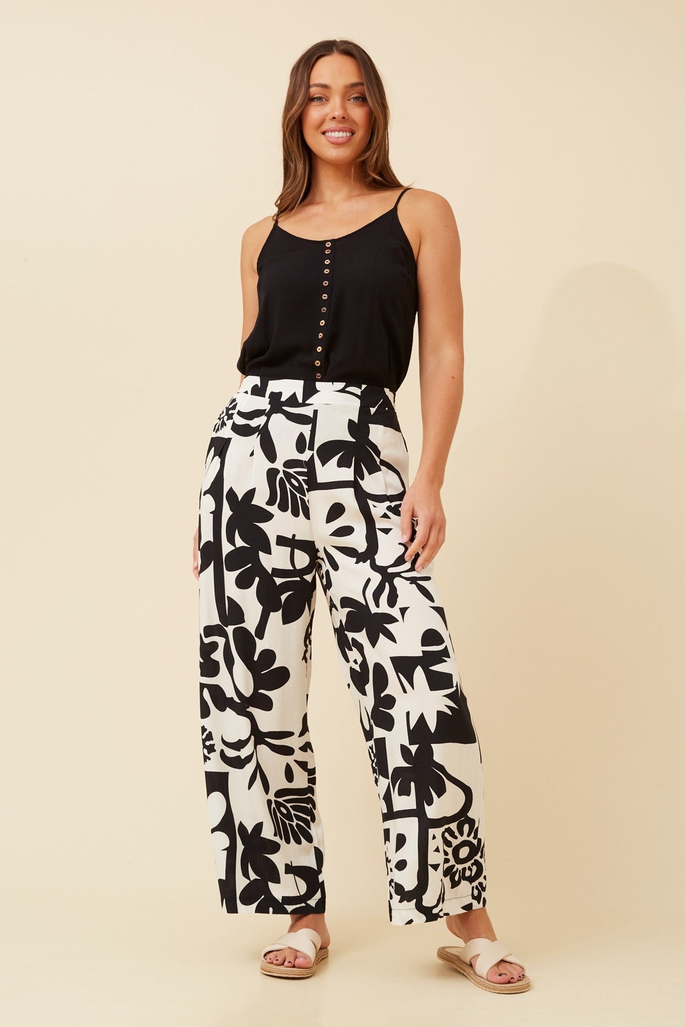 Image of a model wearing Pants. Product name - LOXANA ABSTRACT PRINT PANTS in Beige colour by brand - Caroline Morgan Australia