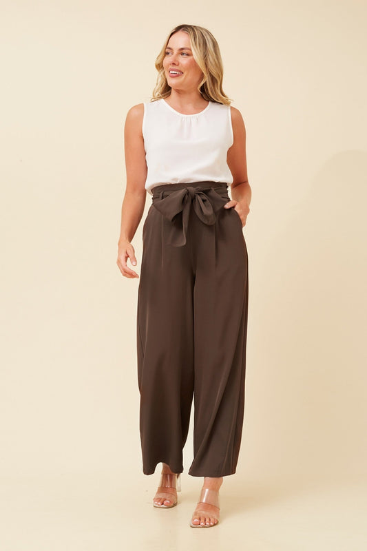 Image of a model wearing Pants. Product name - WINIFRED PAPER BAG PANTS in Black colour by brand - Caroline Morgan Australia