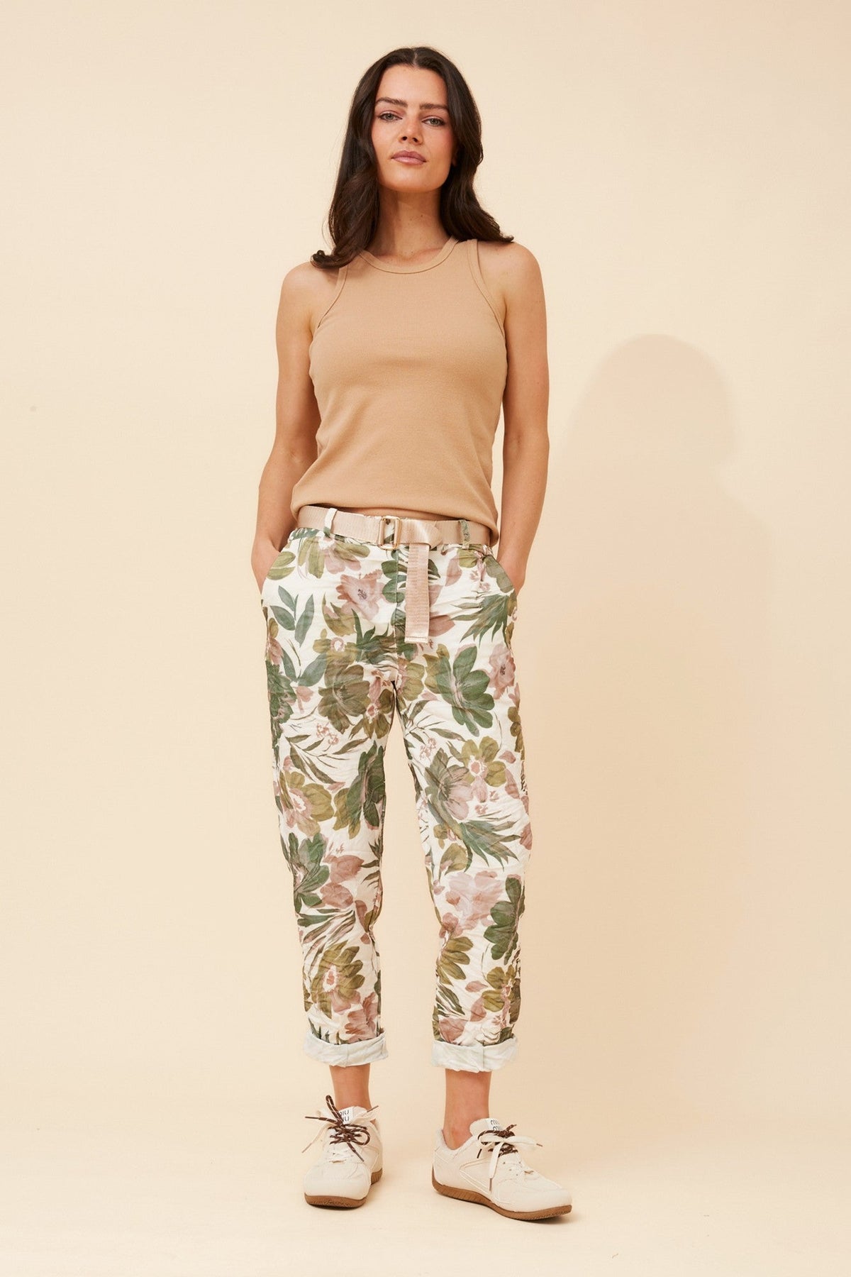 Image of a model wearing Pants. Product name - JANJA FLORAL JOGGER PANTS in Green colour by brand - BOTTEGA MODA