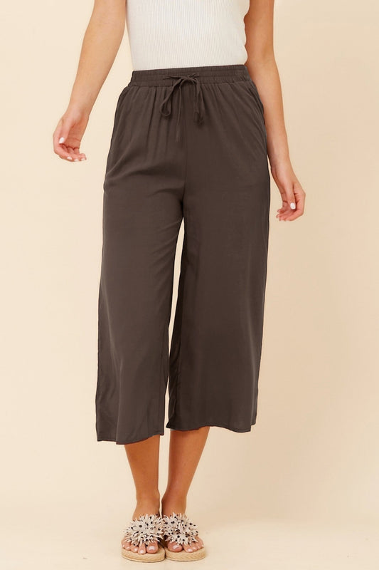 Image of a model wearing Pants. Product name - SUZE SOLID CULOTTE PANTS in Bitter Chocolate colour by brand - Caroline Morgan Australia