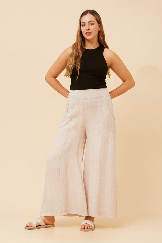 Image of a model wearing Pants. Product name - AMILITA WIDE LEG LINEN PANTS in Linen colour by brand - BOTTEGA MODA